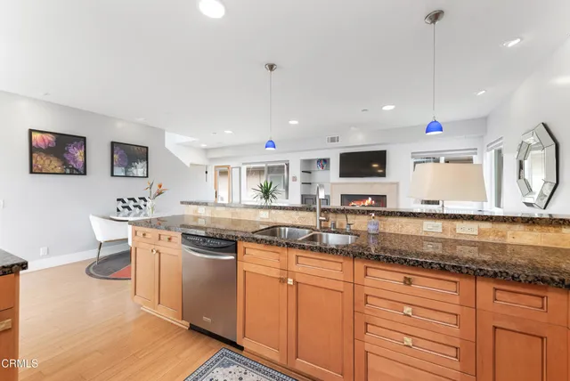 a kitchen with stainless steel appliances granite countertop a sink and a stove