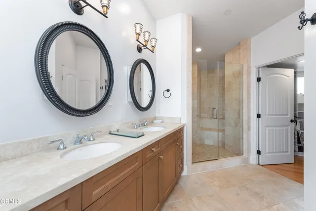 a bathroom with a double vanity sink and a mirror