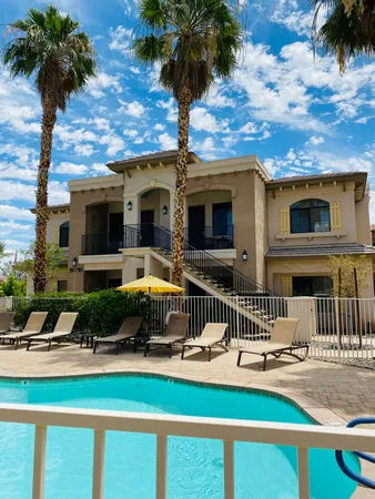 a front view of a house with swimming pool and furniture