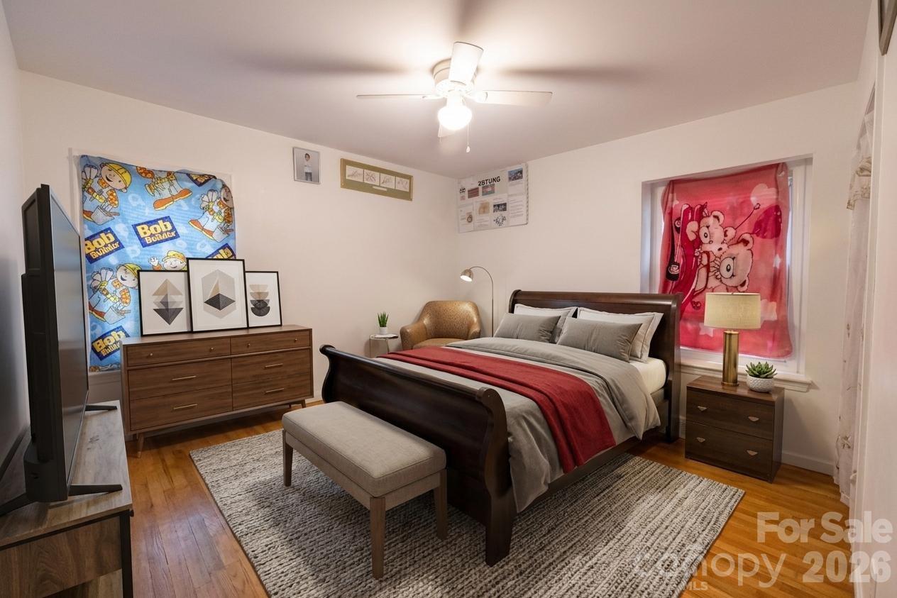 2545 Cedarwild Road Charlotte, NC 28212 - Photo 8 of 25 a bedroom with bed and paintings on the wall