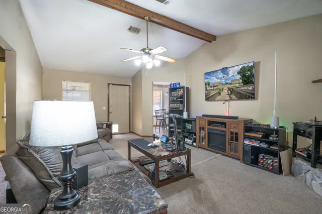 a living room with furniture and a flat screen tv
