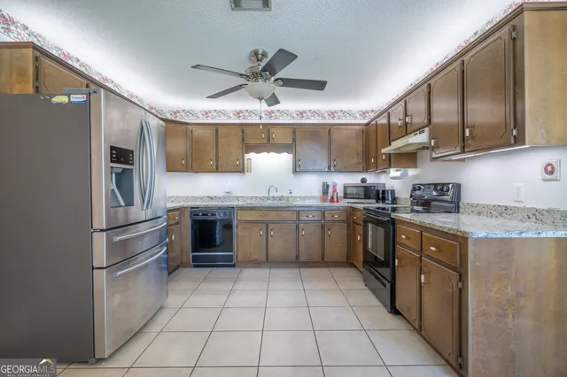 a kitchen with a sink refrigerator and cabinets