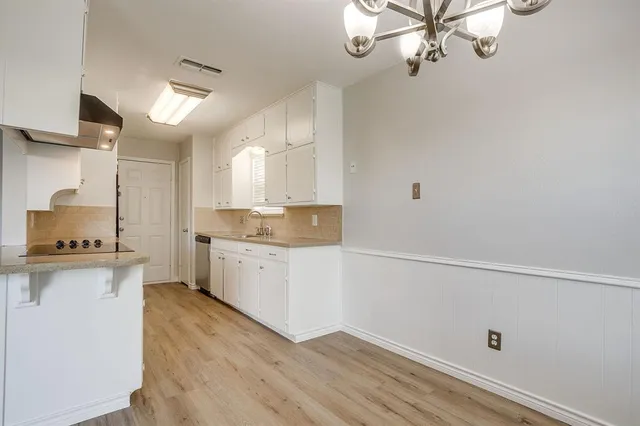 a kitchen with a white cabinets stove and refrigerator