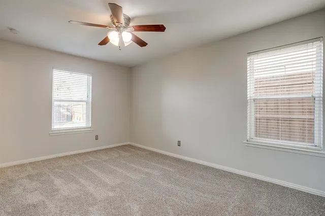 a view of room with a ceiling fan and window
