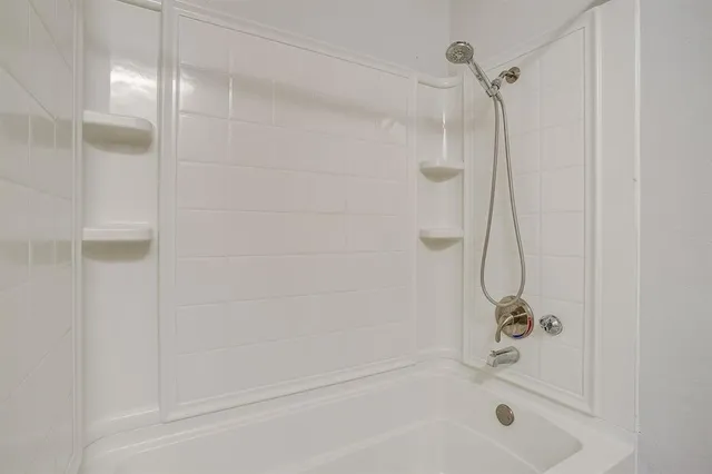 a bathroom with a shower and a bath tub