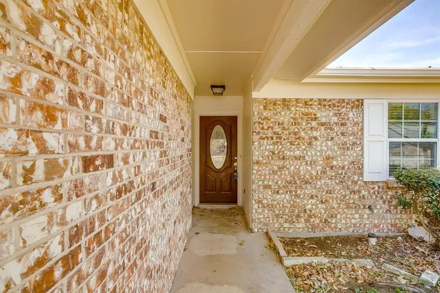 a bathroom with a shower curtain and a window
