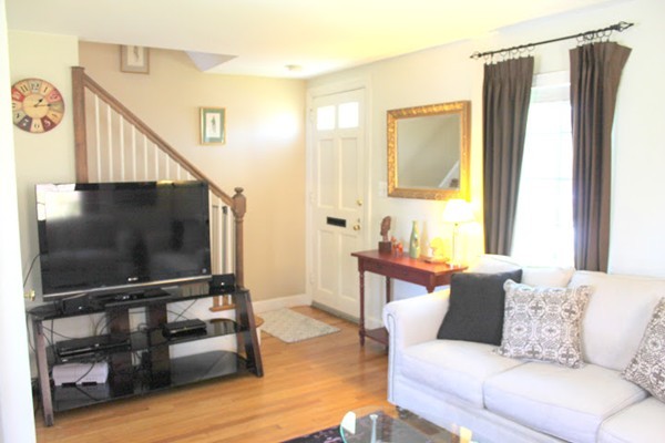 62 Pierce Road, Unit 62 Watertown, MA 02472 - Photo 3 of 14 a living room with furniture and a flat screen tv