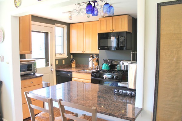 62 Pierce Road, Unit 62 Watertown, MA 02472 - Photo 7 of 14 a kitchen with a stove a sink and a refrigerator