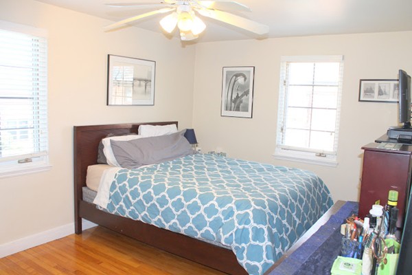 62 Pierce Road, Unit 62 Watertown, MA 02472 - Photo 8 of 14 a bedroom with a bed and wooden floor