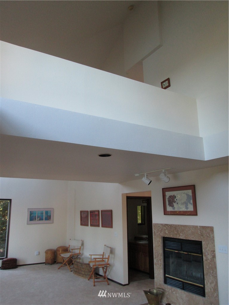 19611 Whiteman Cove Road Southwest Longbranch, WA 98351 - Photo 8 of 25 a living room with furniture and a fireplace