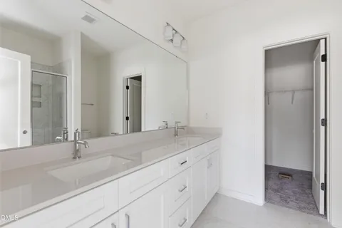 a bathroom with a shower sink vanity and toilet