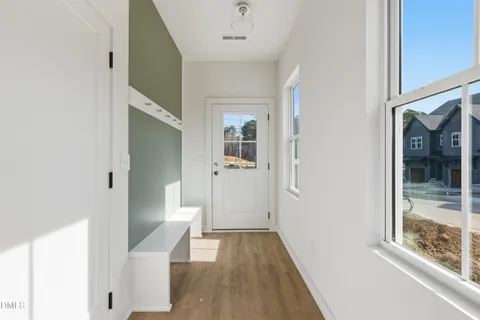 a view of entryway and hall with wooden floor