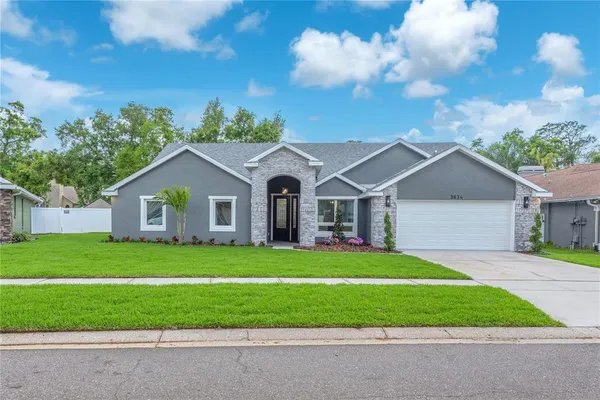 a front view of a house with a yard and garage