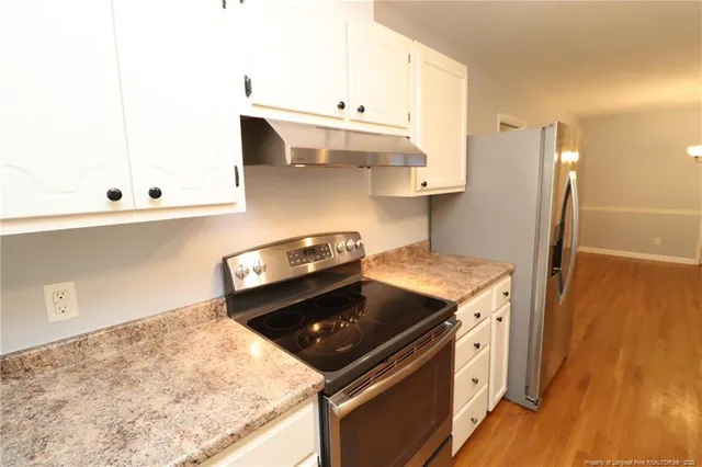 a kitchen with a stove and a refrigerator