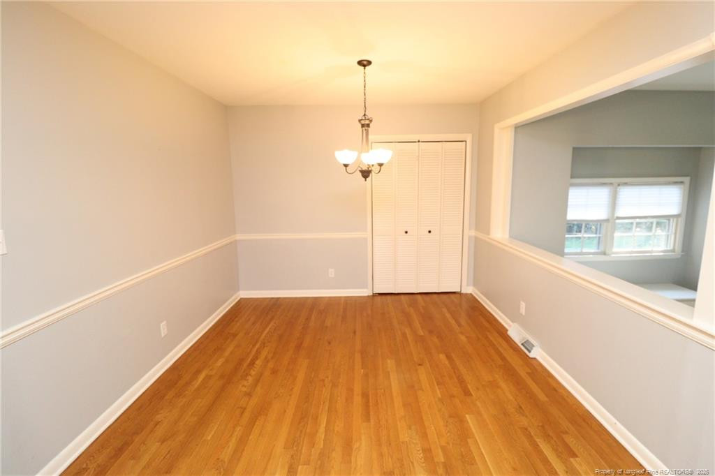 4909 Auburn Road Raleigh, NC 27609 - Photo 18 of 33 a view of a room with wooden floor and window