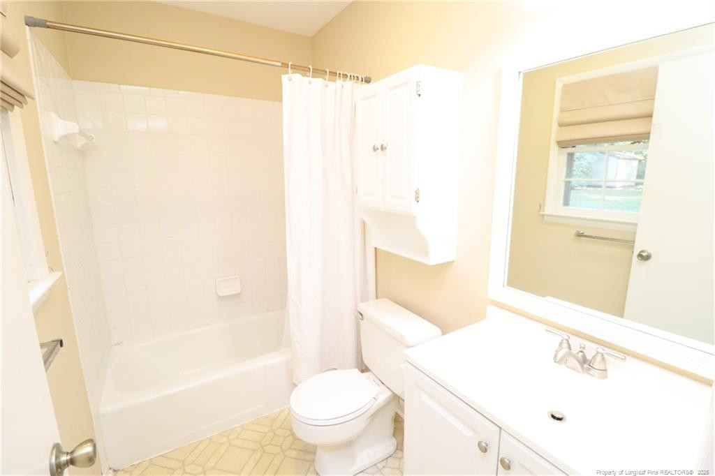 4909 Auburn Road Raleigh, NC 27609 - Photo 29 of 33 a bathroom with a sink a toilet and shower