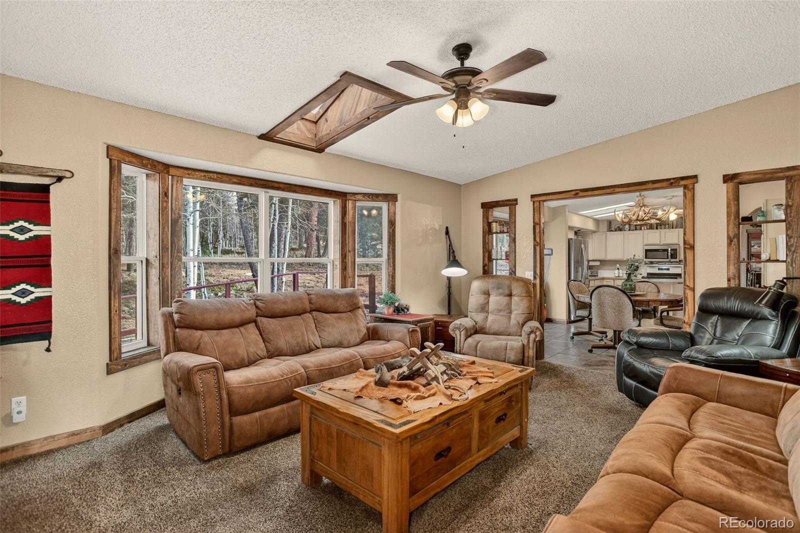50 Rd P78 Bailey, CO 80421 - Photo 12 of 48 a living room with furniture a ceiling fan and a large window