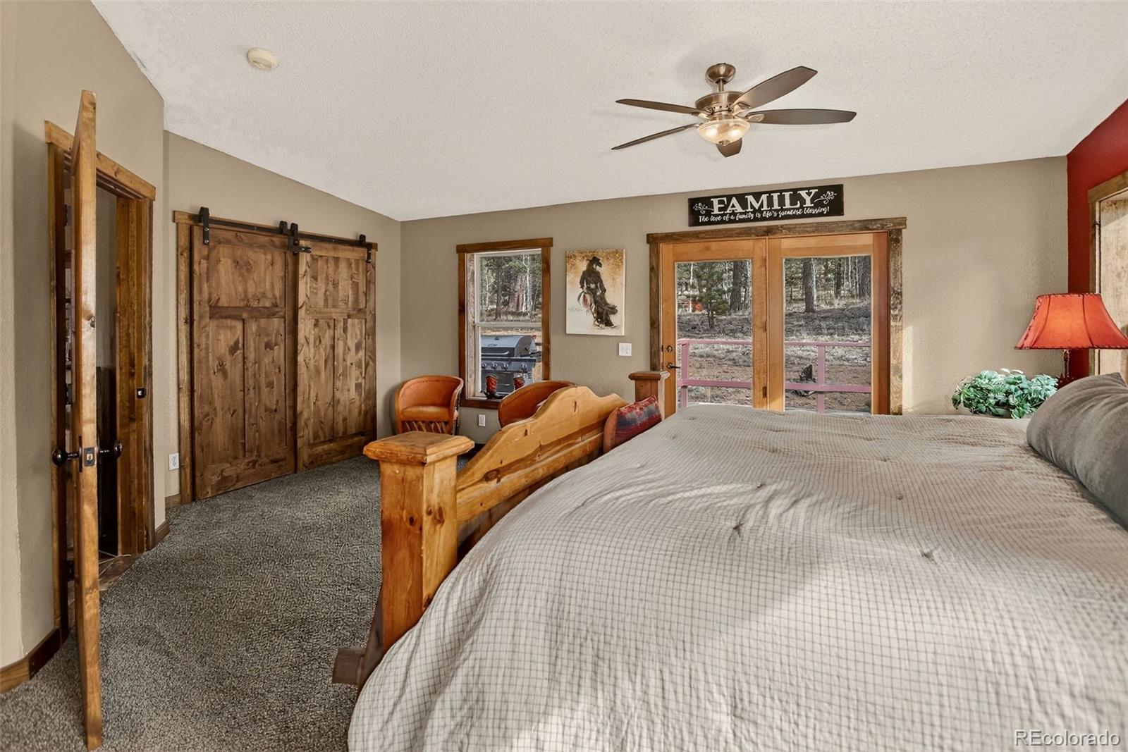 50 Rd P78 Bailey, CO 80421 - Photo 15 of 48 a spacious bedroom with a large bed chandelier and a window