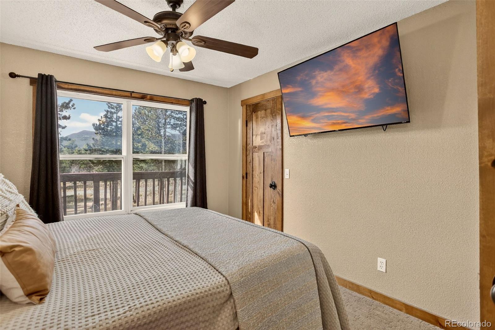 50 Rd P78 Bailey, CO 80421 - Photo 21 of 48 a bedroom with a large bed and a chandelier