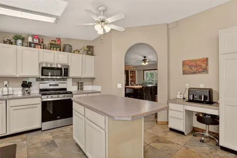 a kitchen with kitchen island a counter appliances and cabinets
