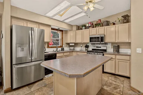 a view of kitchen island with furniture and chandelier