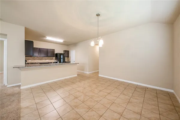 a view of a kitchen with microwave and cabinets