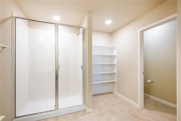 a bathroom with a glass shower door