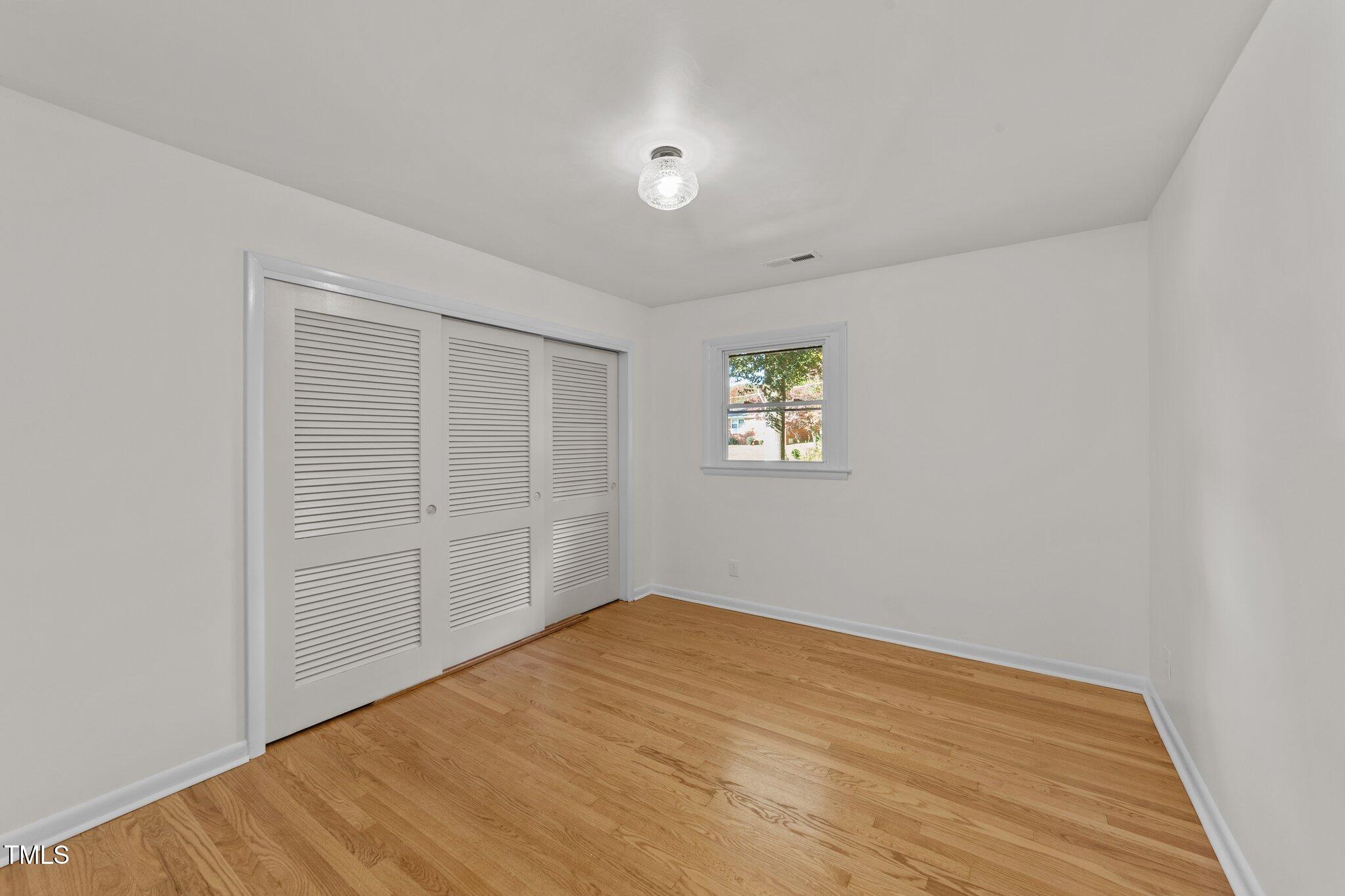 4601 Forestdale Road Raleigh, NC 27603 - Photo 17 of 46 an empty room with windows