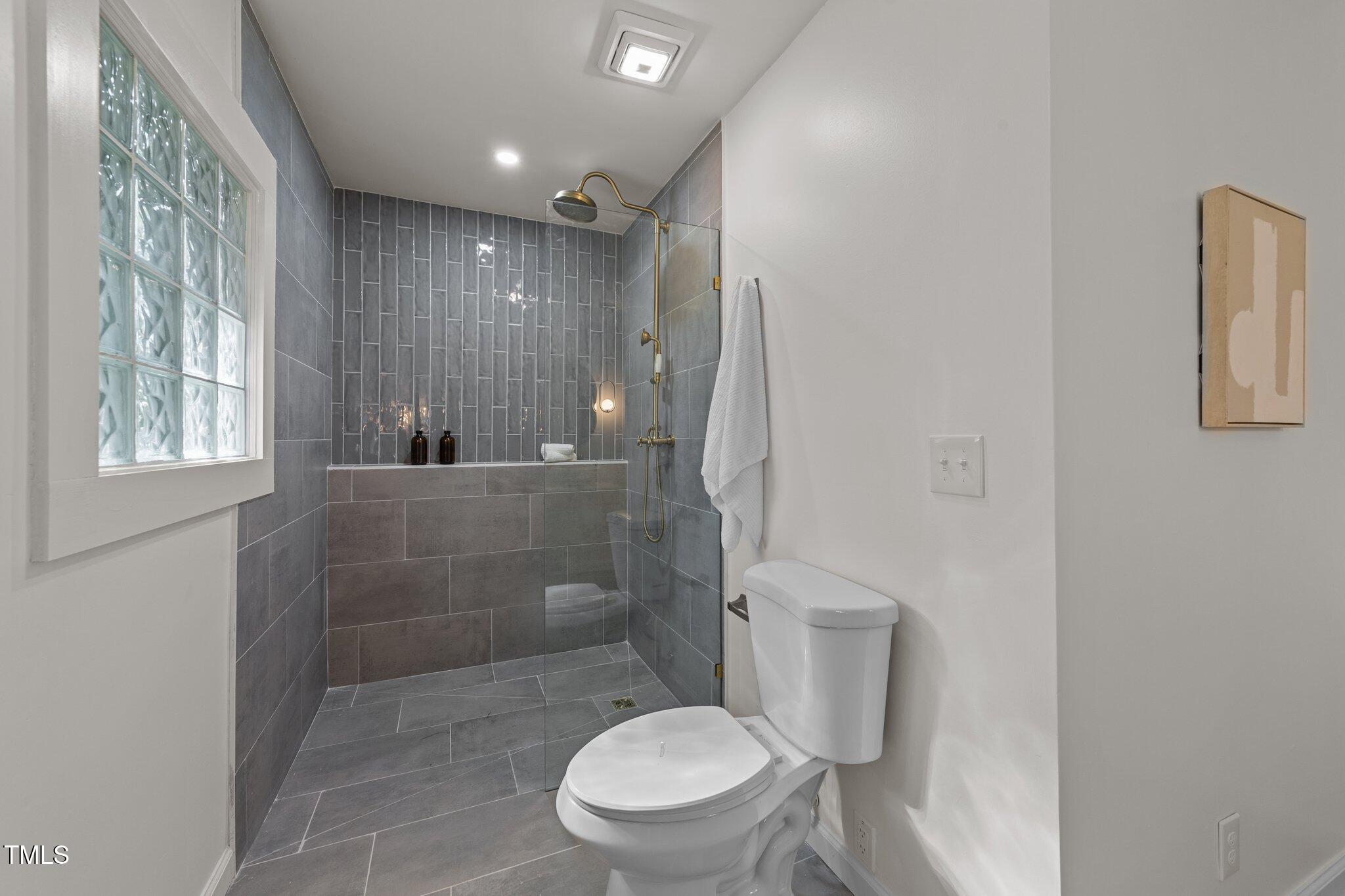 4601 Forestdale Road Raleigh, NC 27603 - Photo 23 of 46 a bathroom with a toilet and a shower