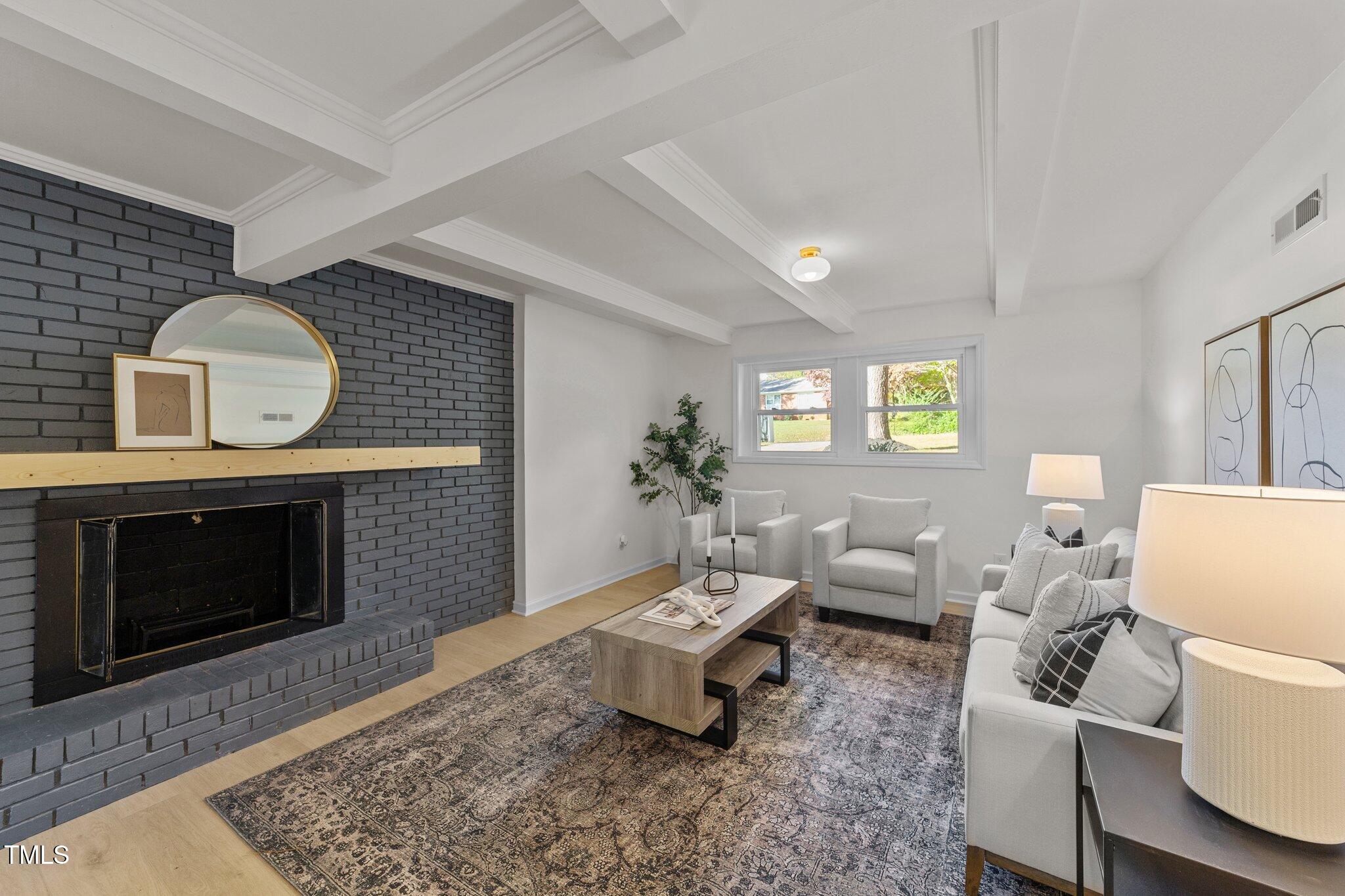 4601 Forestdale Road Raleigh, NC 27603 - Photo 24 of 46 a living room with furniture and a fireplace