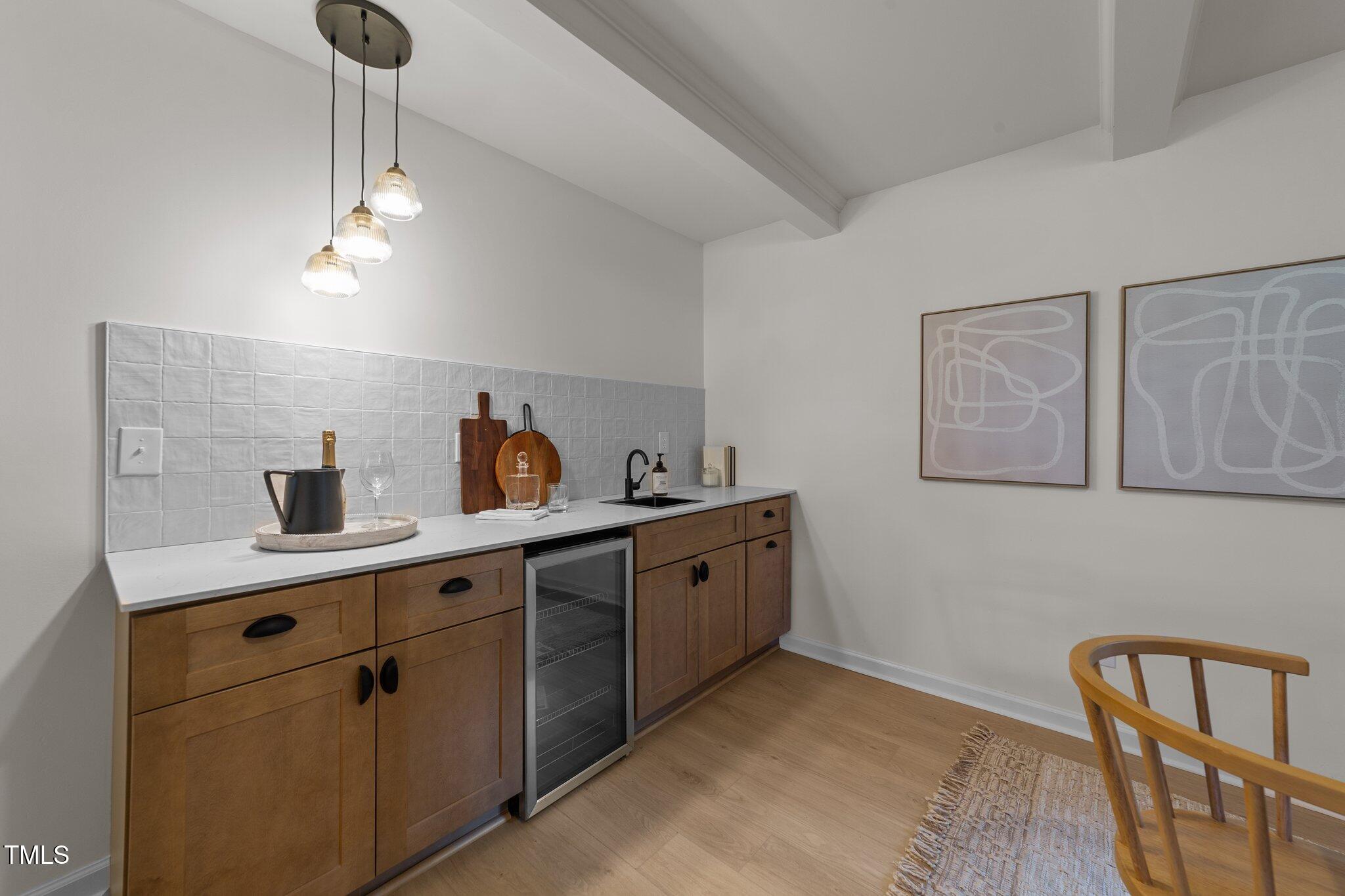 4601 Forestdale Road Raleigh, NC 27603 - Photo 28 of 46 a kitchen with a sink a stove cabinets and living room view
