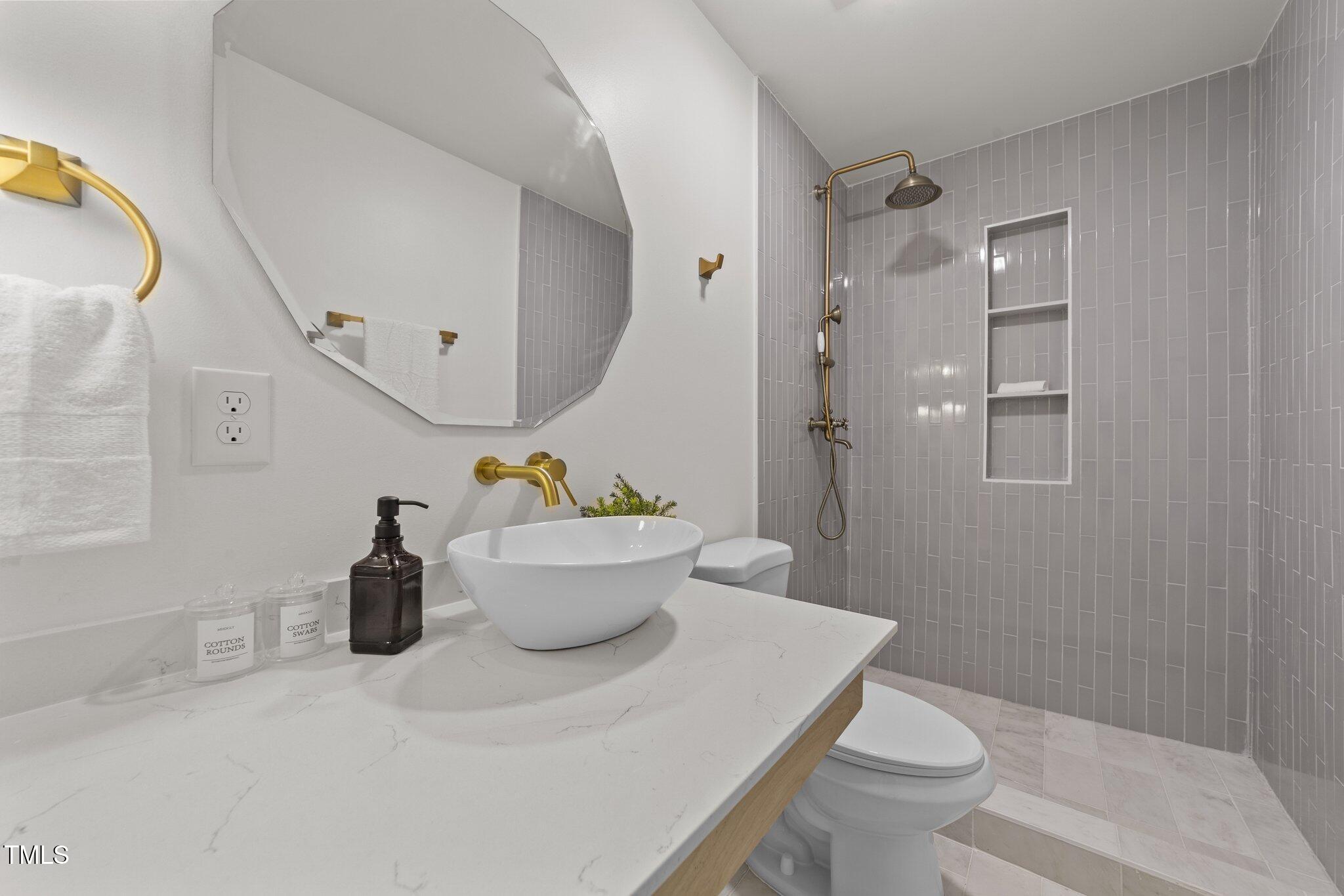 4601 Forestdale Road Raleigh, NC 27603 - Photo 30 of 46 a bathroom with a sink toilet and shower