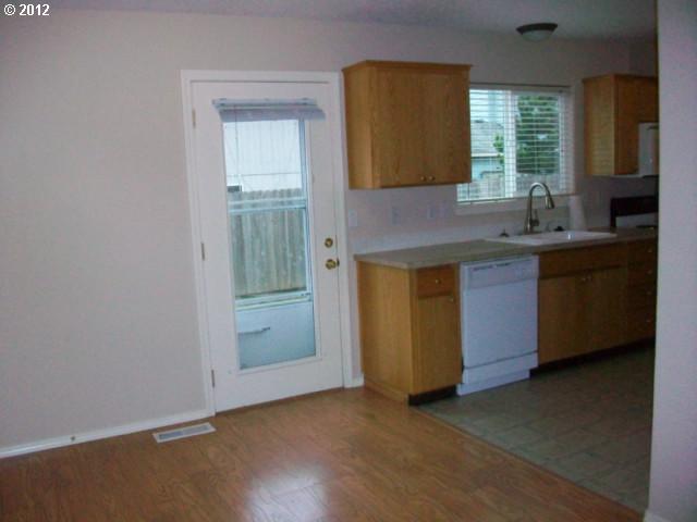 1111 Southwest Ivory Loop Gresham, OR 97080 - Photo 5 of 8 a kitchen with a sink and cabinets