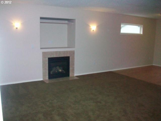 1111 Southwest Ivory Loop Gresham, OR 97080 - Photo 6 of 8 a view of empty room with a fireplace