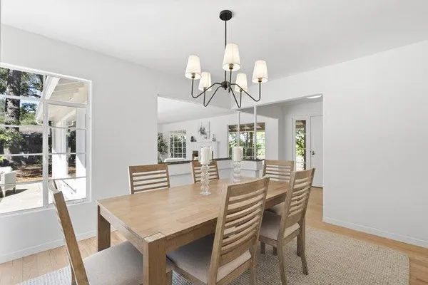 a view of a dining room with furniture wooden floor and chandelier