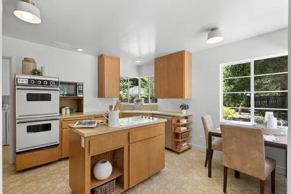 a kitchen that has a stove and a table