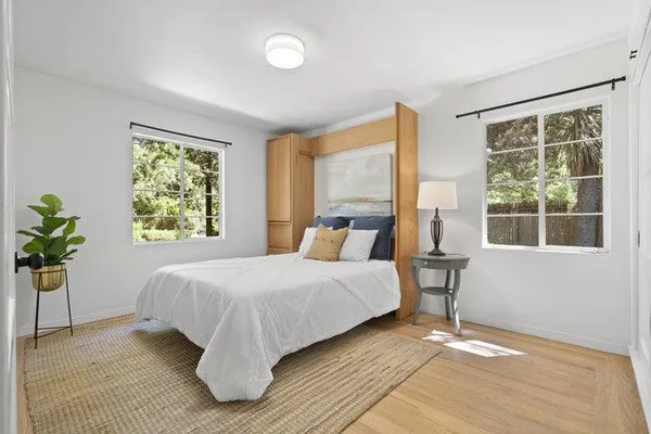 a bedroom with a bed and glass window