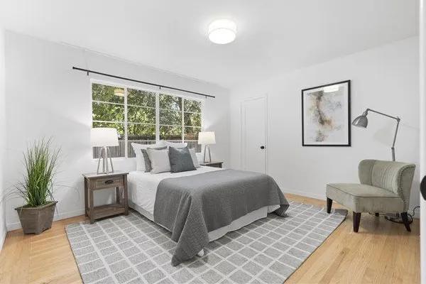 a bedroom with a bed and a couch