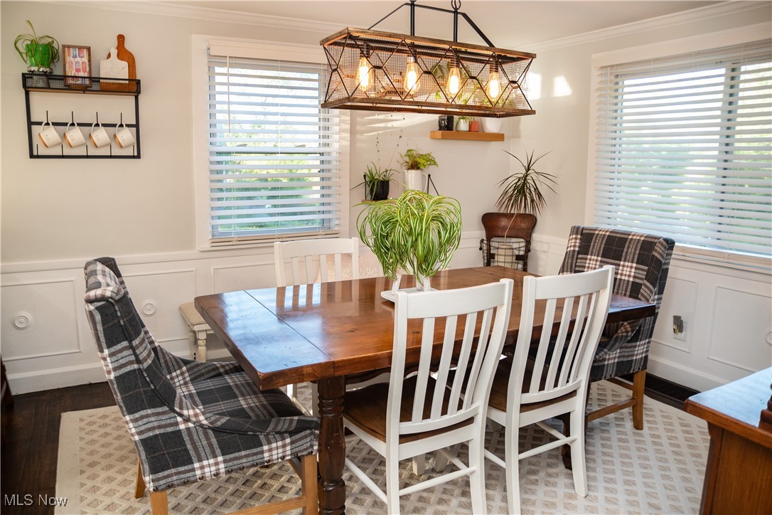 95 Clingan Road Struthers, OH 44471 - Photo 23 of 46 Dining room with a decorative wall, wainscoting, crown molding, plenty of natural light, and wood finished floors