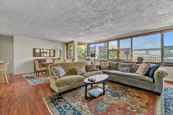 a living room with furniture and a floor to ceiling window