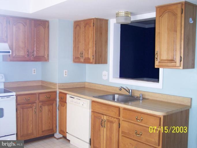 8532 Bauer Drive Springfield, VA 22152 - Photo 4 of 12 a utility room with sink dryer and cabinet