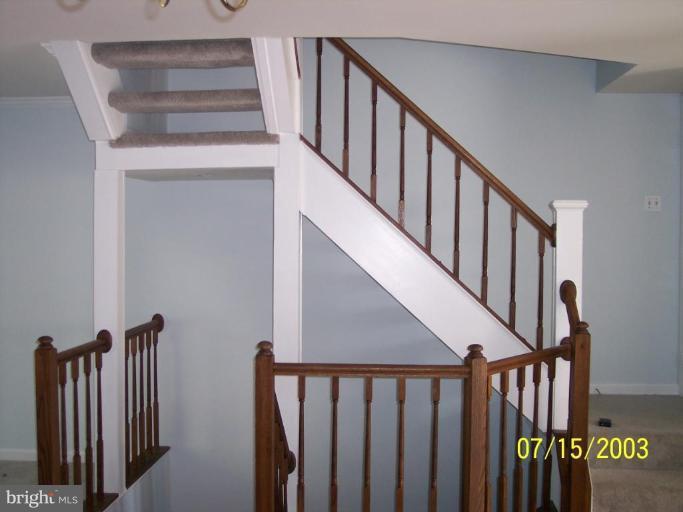 8532 Bauer Drive Springfield, VA 22152 - Photo 7 of 12 a view of staircase with lots of frames on wall