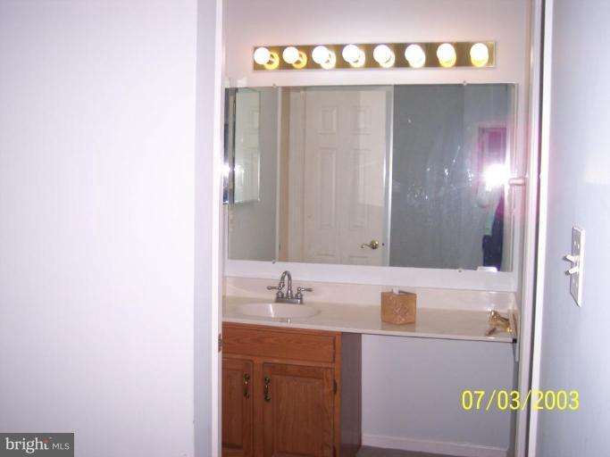 8532 Bauer Drive Springfield, VA 22152 - Photo 10 of 12 a bathroom with a sink and a mirror