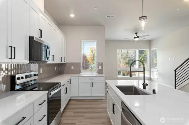 a kitchen with a sink stove and microwave