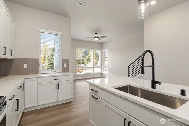 a kitchen with a sink cabinets and window