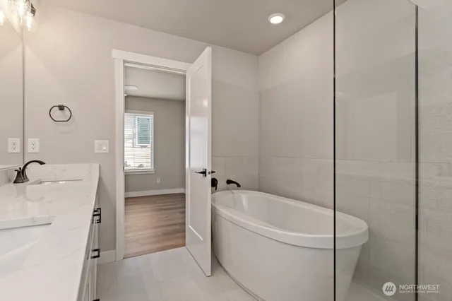a white bath tub sitting next to a shower