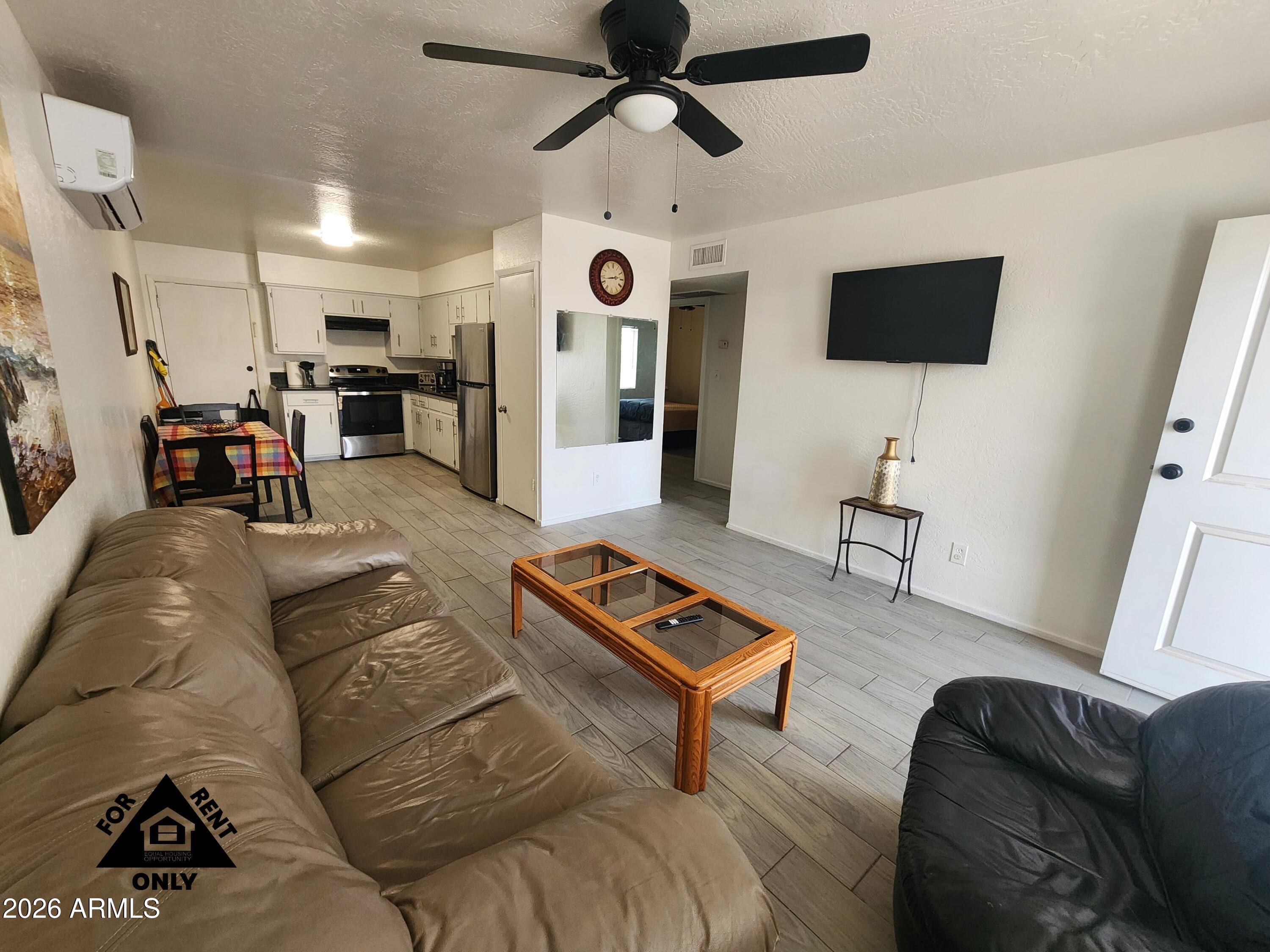 2001 West Turney Avenue, Unit 6 Phoenix, AZ 85015 - Photo 2 of 10 a living room with furniture and a flat screen tv