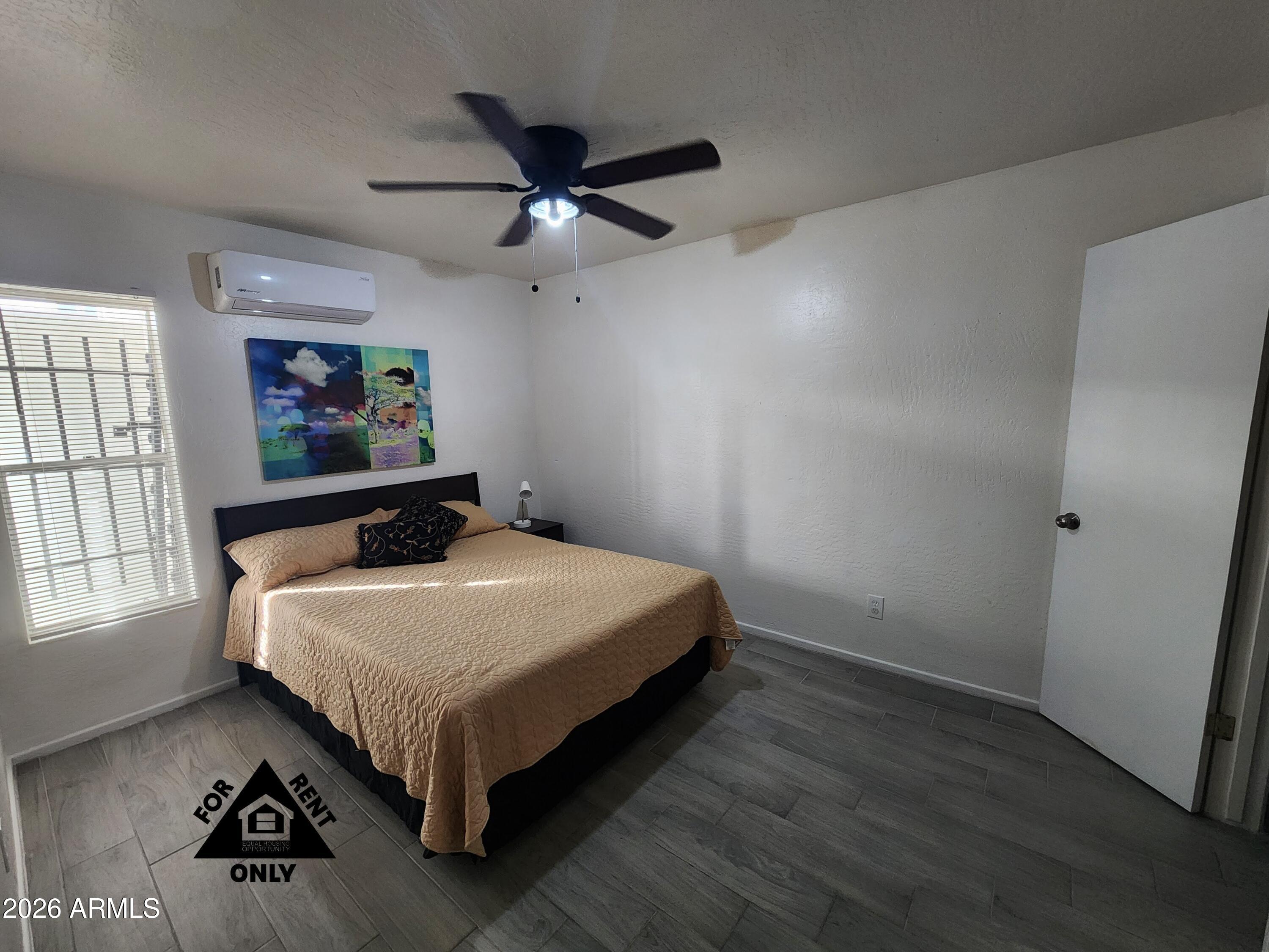 2001 West Turney Avenue, Unit 6 Phoenix, AZ 85015 - Photo 5 of 10 a bedroom with a bed and window