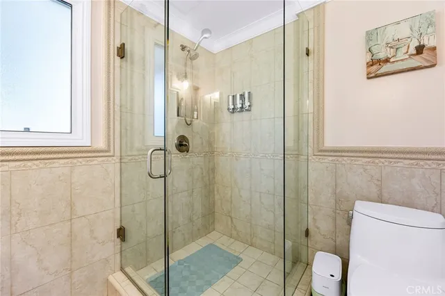 a bathroom with a shower and toilet
