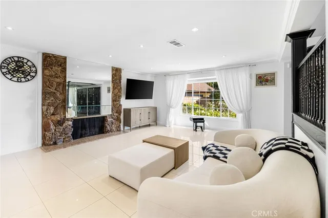 a living room with fireplace furniture and a flat screen tv